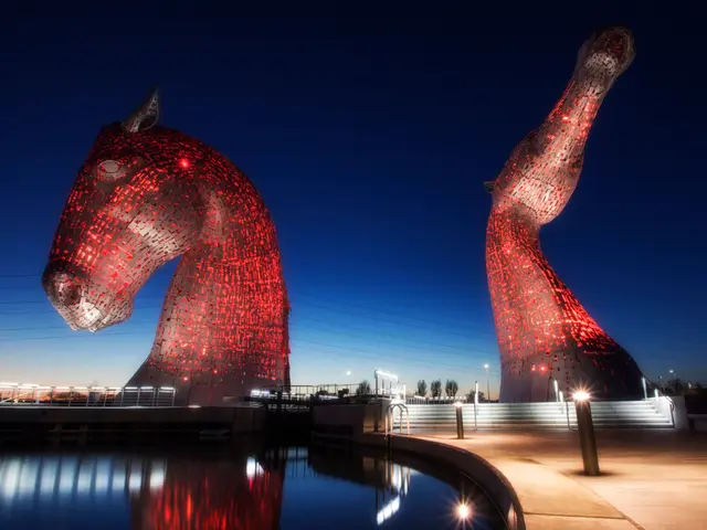 This picture is clicked outside the city. In the foreground we can see a water body, lights, poles...