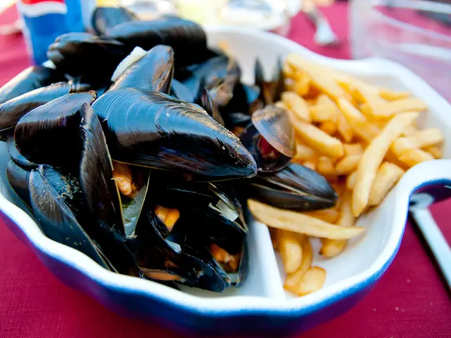 In this image, I can see sea food, french fries in a bowl and glasses, bowl, bottle maybe on a...