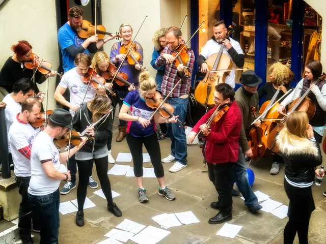 Here we can see a group of people playing violins and there are papers here and there on the ground