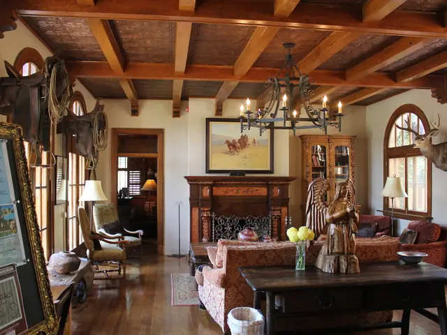 The picture is taken in a room. On the left there are chairs, windows, table, frame and other...
